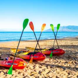 a boat sitting on top of a sandy beach