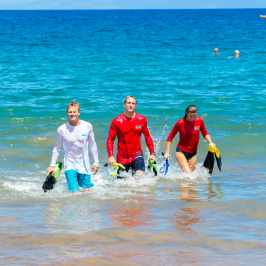 a group of people standing next to a body of water