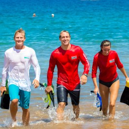 people walking towards beach from shore