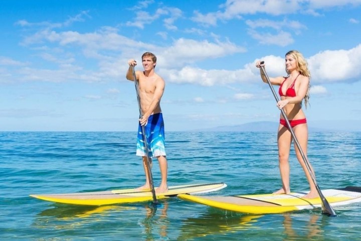 a person riding a surf board on a body of water